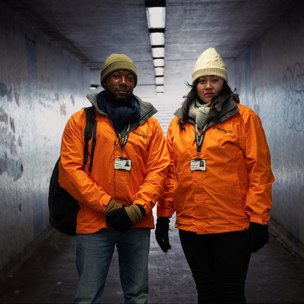 Two St Mungo's volunteers in uniform stood in an underpass