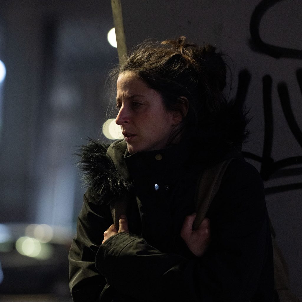 Nighttime portrait of person outdoors in coat