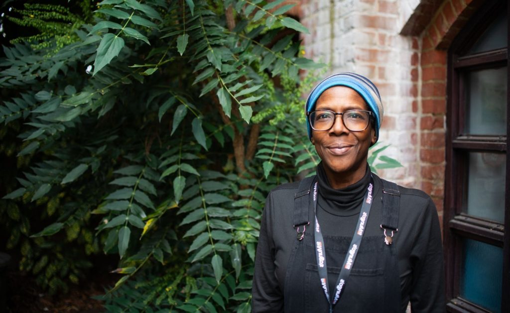 St Mungo's staff member stood in a garden